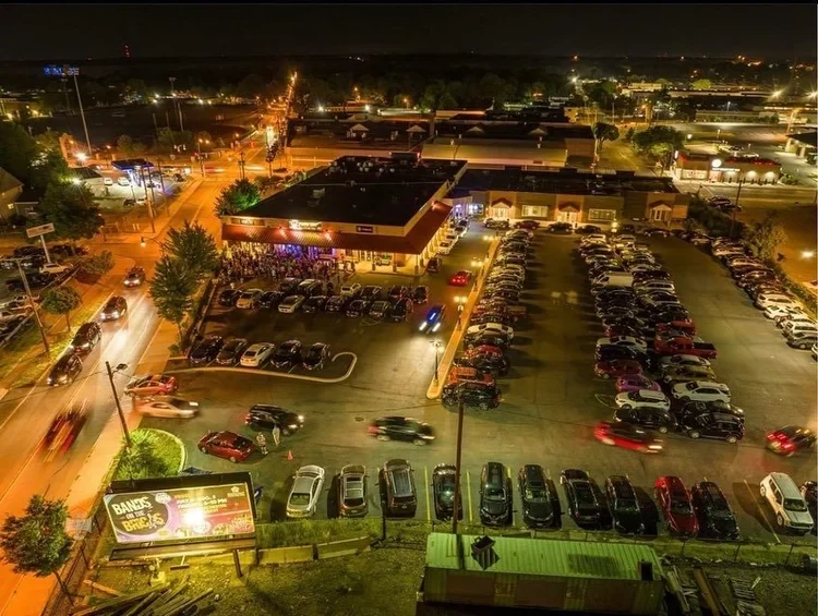 Aerial view of Photo City Music Hall and parking lot at night